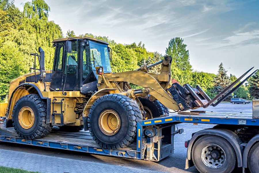 The trailer platform with yellow earth mover